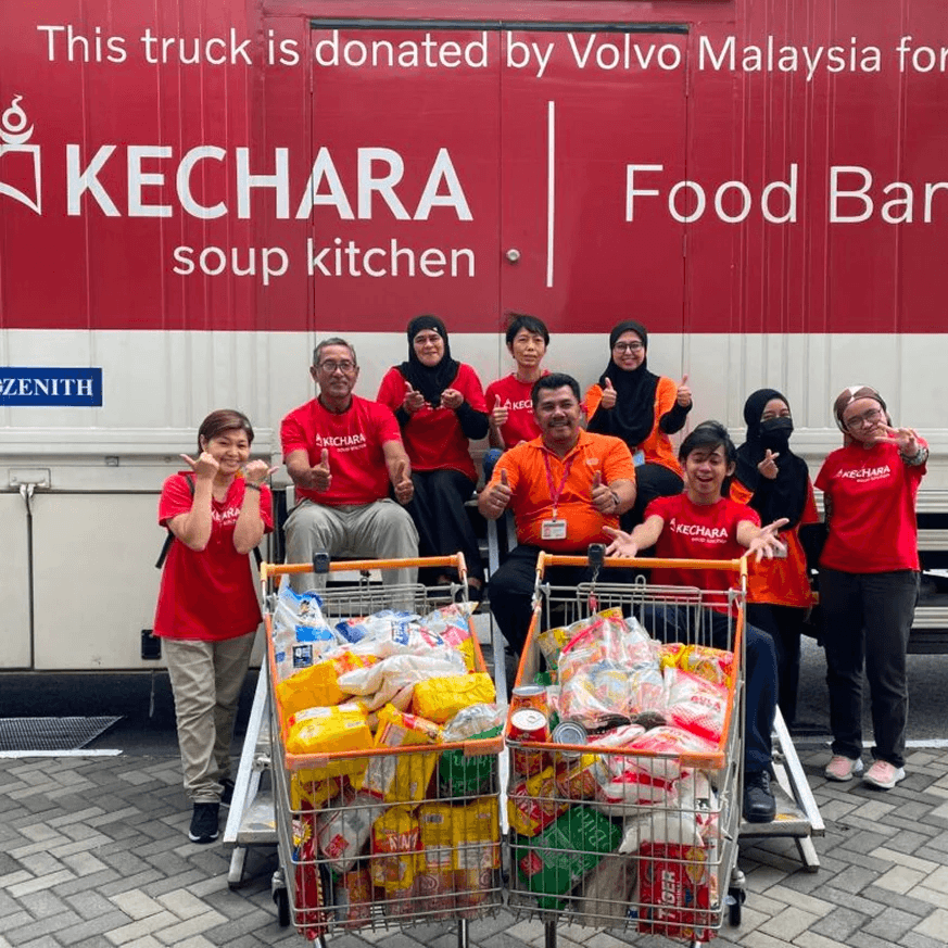 Volunteers from Penang distributing food packs to beneficiaries