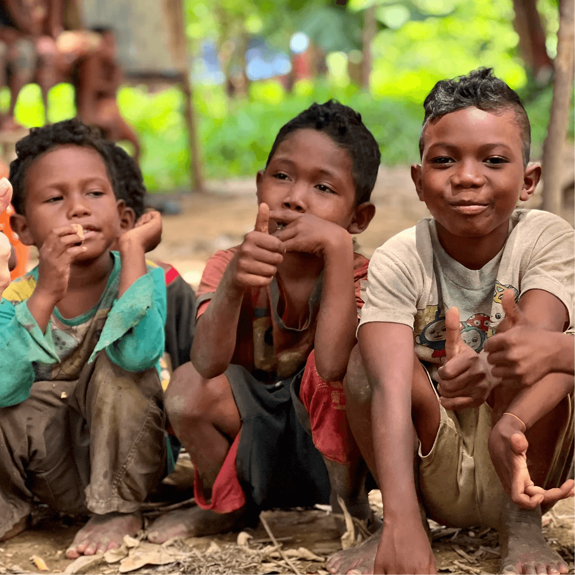 Three Orang Asli kids sitting together