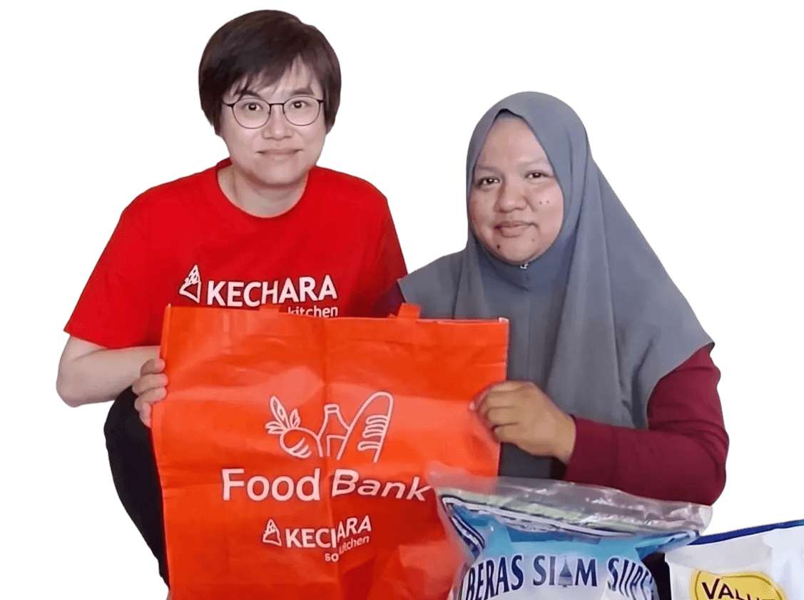 Two beneficiaries receiving aid from Kechara Soup Kitchen showing thumbs up